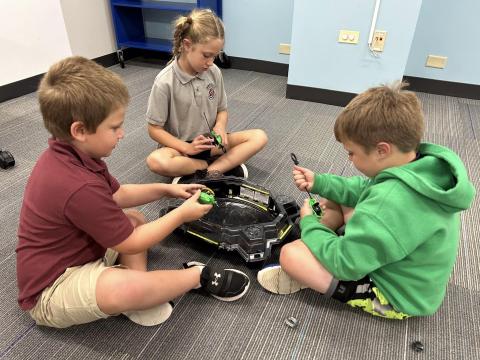 kids playing with Beyblades