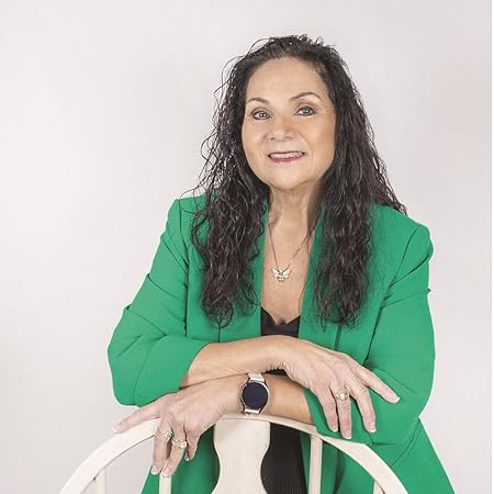 White woman with long black hair and green blazer 