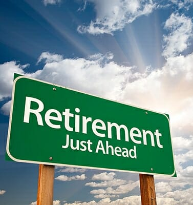 Green road sign with white retirement just ahead text