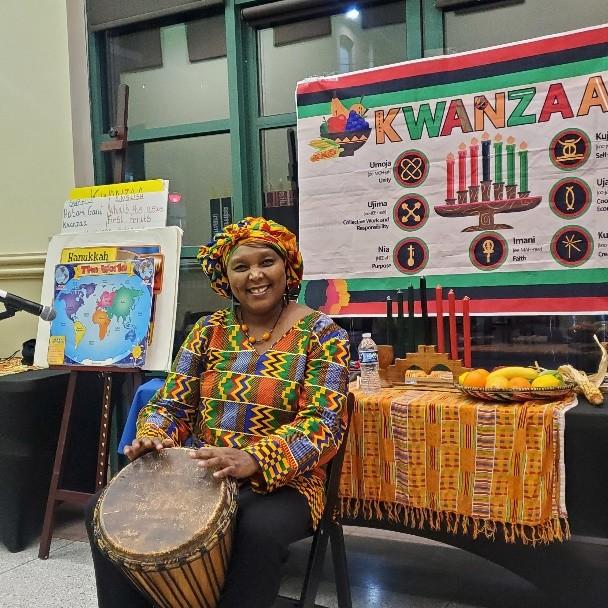 woman with drum by Kwanzaa display